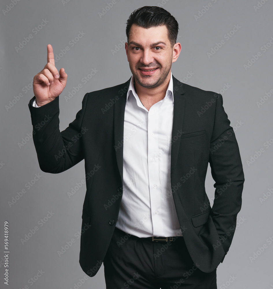 Handsome happy businessman gesture his finger up Handsome happy businessman gesture his finger up