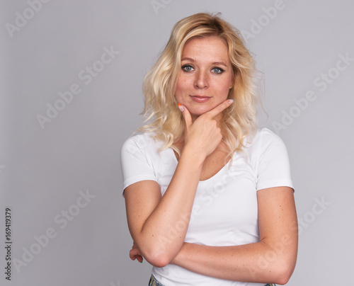 thoughtful Beautiful young blonde woman with freckles