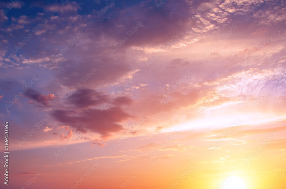 Pink sunset against the background of a bright sun.