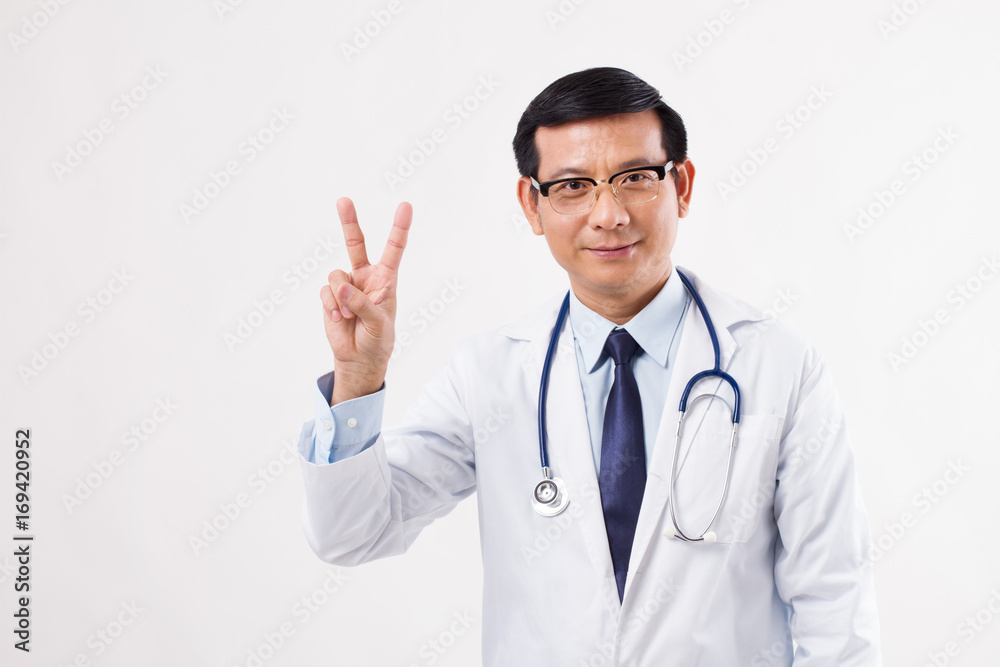 confident asian male doctor pointing up 2 fingers, victory hand gesture confident asian male doctor pointing up 2 fingers, victory hand gesture