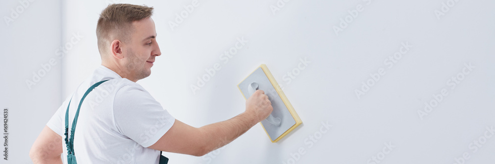 Plasterer finishing wall with float Plasterer finishing wall with float