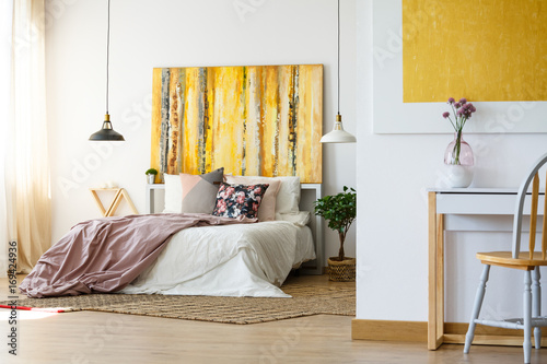 Energetic bedroom with yellow artwork