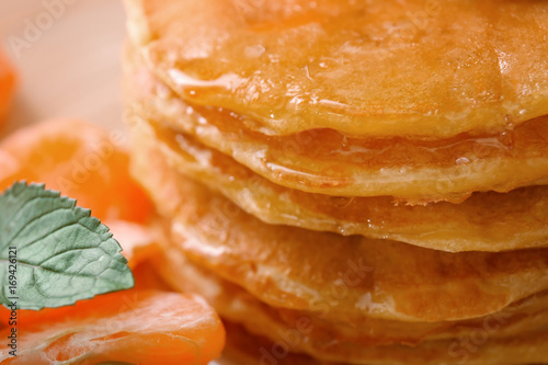 Delicious pancakes with honey, close up