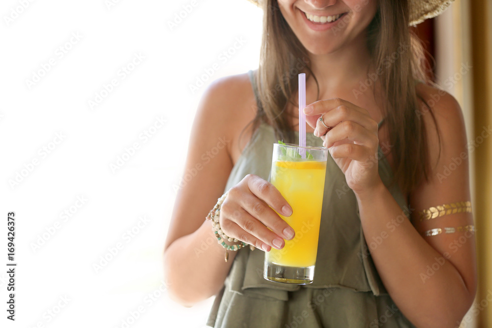 Beautiful young woman with glass of lemonade on light background Beautiful young woman with glass of lemonade on light background