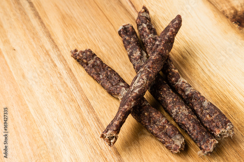 Droewors (biltong) on a wooden board. This is a popular South African food snack. 