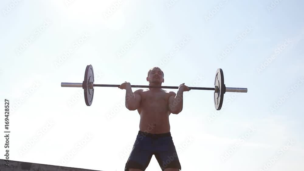 Athlete training with barbell . Slow motion. Athlete training with barbell . Slow motion.