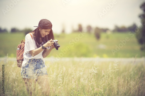 Outdoor summer smiling lifestyle portrait of pretty young woman having fun with camera travel photo of photographer Making pictures