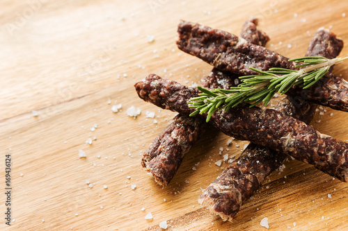 Droewors (biltong) on a wooden board. This is a popular South African food snack. 