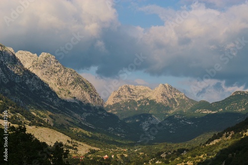 Clouds above the north Albanian mountains, at sunset time. Seen from the village Boge next to Theth National Park in Albania. Southeast Europe. © utamaria