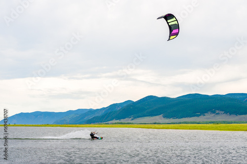 Athlete train by kitesurfing on the lake  photo