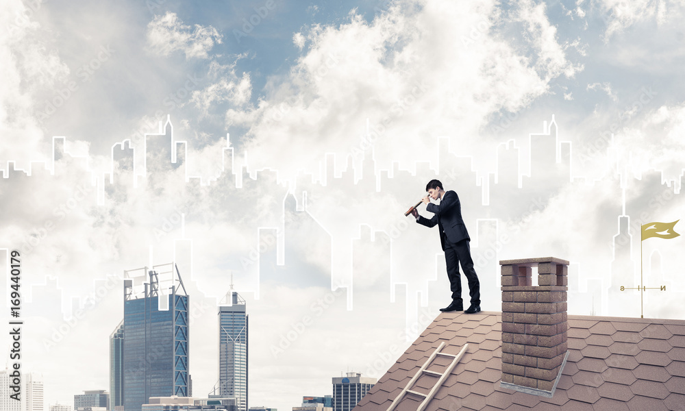 Engineer man standing on roof and looking in spyglass. Mixed med Engineer man standing on roof and looking in spyglass. Mixed med