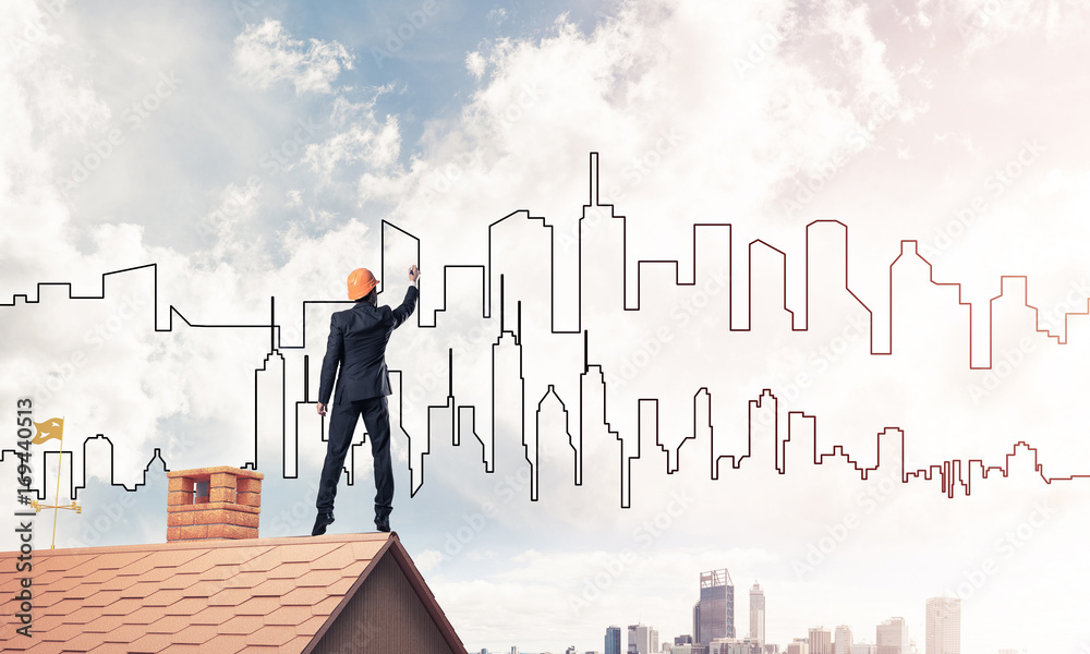 Man architect draw silhouette of modern city on blue sky. Mixed Man architect draw silhouette of modern city on blue sky. Mixed