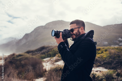 Photographer photographing in nature on winter day photo