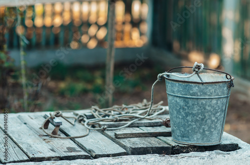 A well with an old bucket in the Village photo