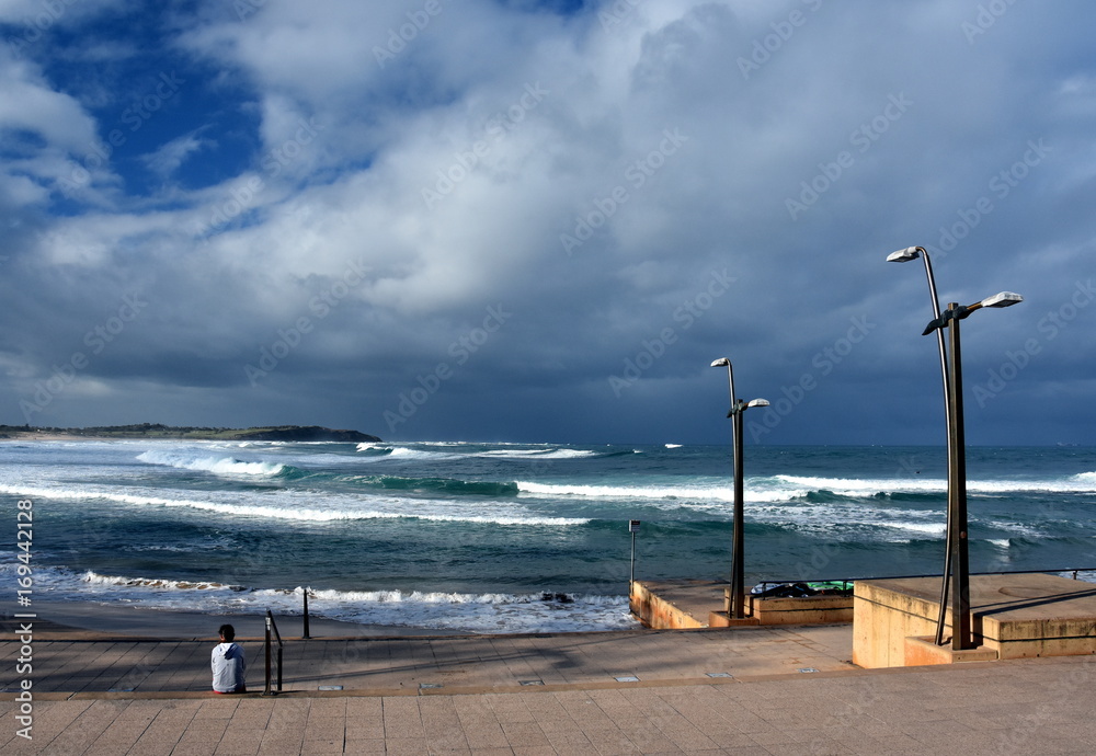Dramatic sky with large clouds over Dee Why beach and Tasman sea (NSW, Australia)