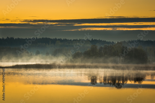 Sunrise over the lake Pozezdrze on Masuria, Poland © Artur Bociarski