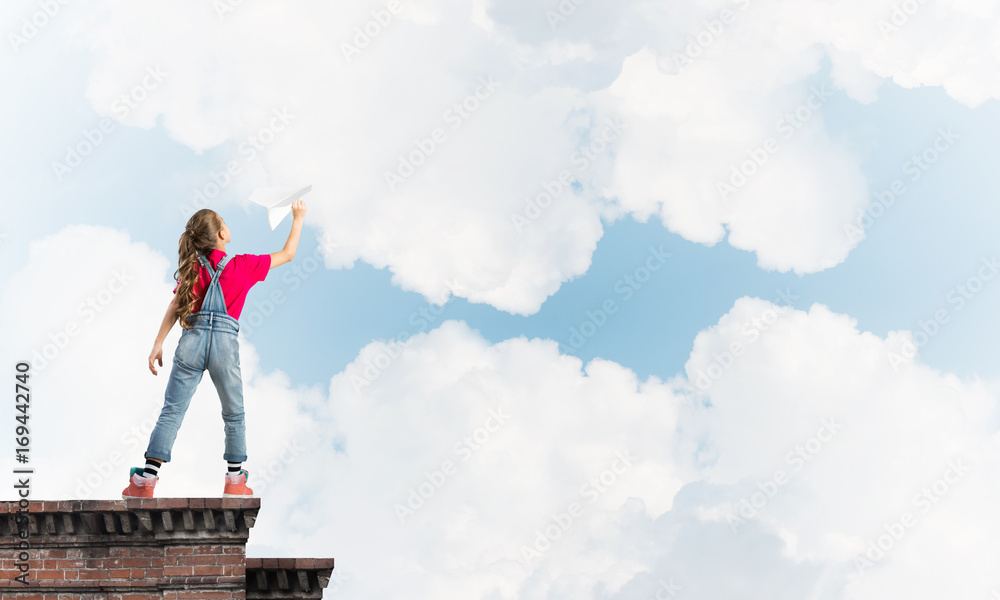 Concept of careless happy childhood with girl dreaming to become pilot Concept of careless happy childhood with girl dreaming to become pilot