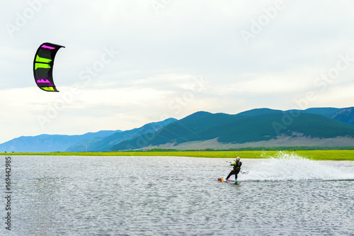 Athlete train by kitesurfing on the lake  photo