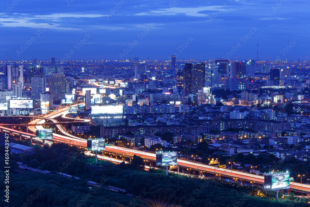 city skyline with highway and railway at sunset, long exposure photography for traffic movement