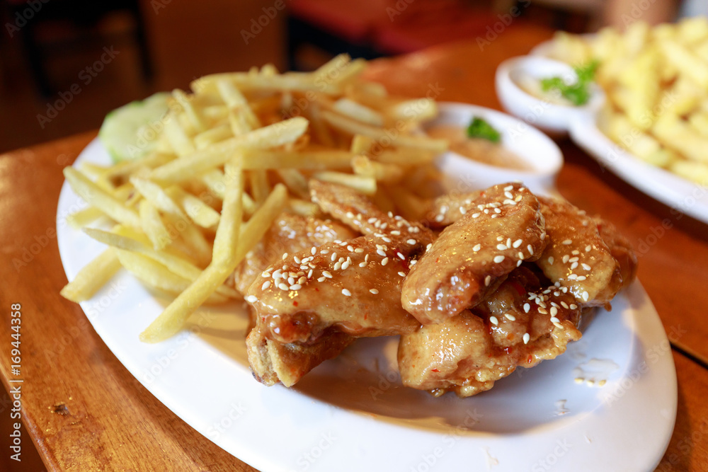 chicken and fries on the table chicken and fries on the table