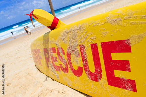 Obraz na plátne Yellow surf rescue board by the sea beach.