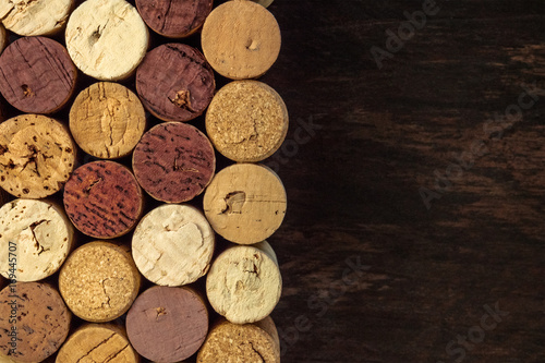Wine corks on dark wooden texture with copyspace