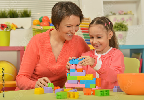 mother and daughter collecting blocks