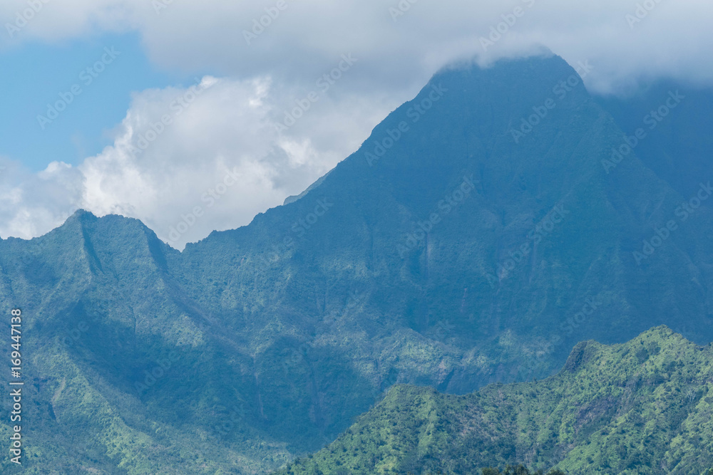 Mount Waialeale on a cloudy day, with a lush jungle in the foreground Mount Waialeale on a cloudy day, with a lush jungle in the foreground