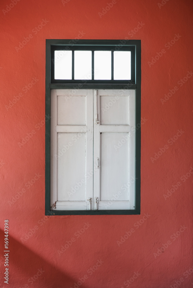 White vintage window on red wall background
