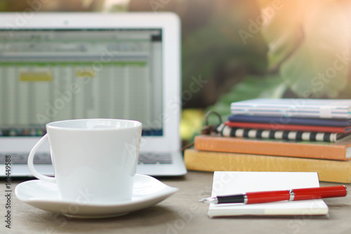 Wallpaper Mural Laptop spread sheet, coffee cup, books and notebook blank page with red pen on business desk business garden background concept Torontodigital.ca