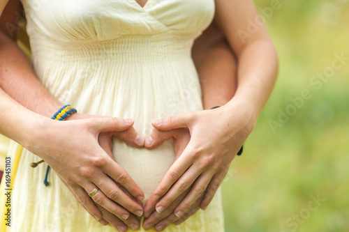 Wallpaper Mural Hands of mom and dad  on pregnant belly Torontodigital.ca