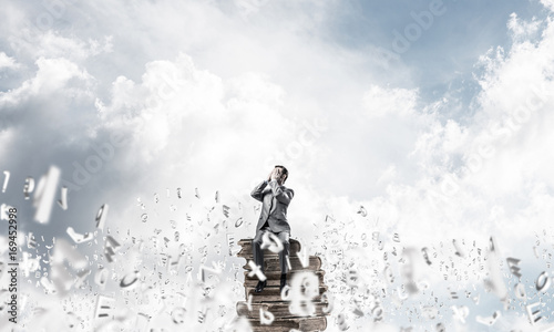 Young man floating in sky and do not want to see anything