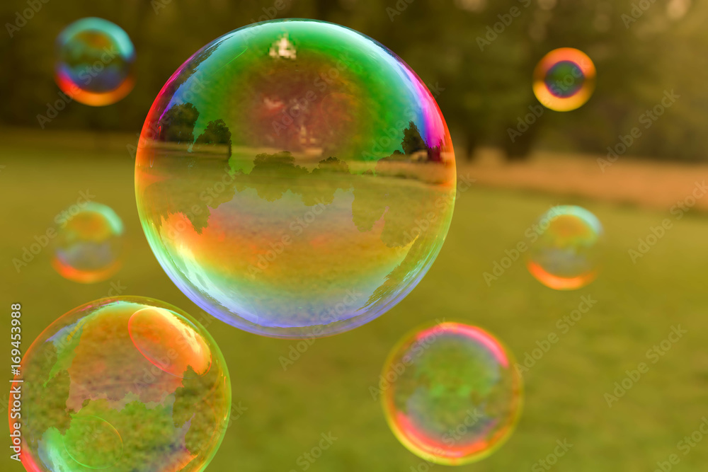 Colorful soap bubbles floating through the air Colorful soap bubbles floating through the air