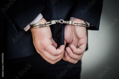 Фотография Businessman handcuffed for corruption, money laundering, tax evasion, antitrust
