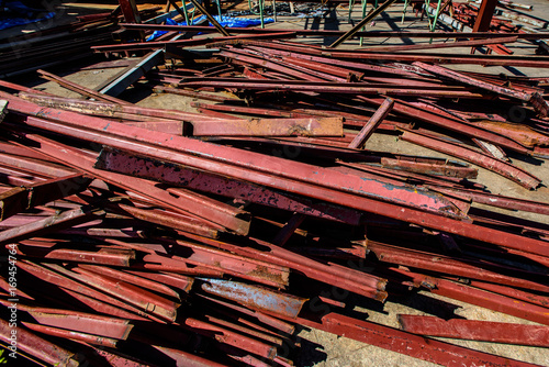 Rusty used steel pile at construction site. Unbuild Site with messy rusty steel stack at yard.  photo