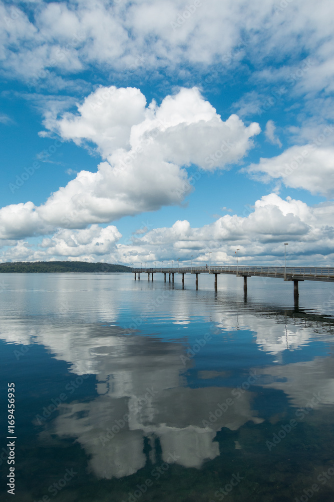 Fishing pier with puffy clouds