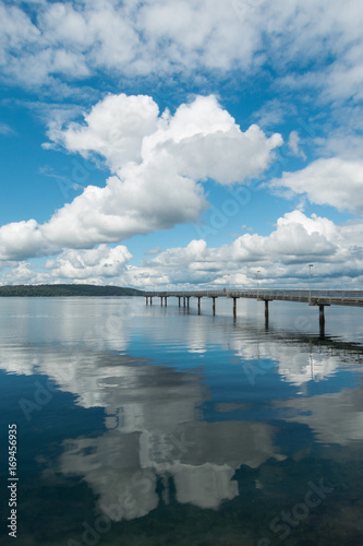 Fototapeta Naklejka Na Ścianę i Meble -  Fishing pier with puffy clouds