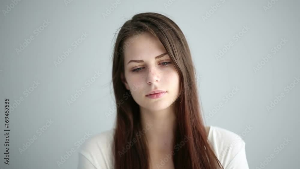 Portrait of a beautiful girl in the studio on a gray background Portrait of a beautiful girl in the studio on a gray background