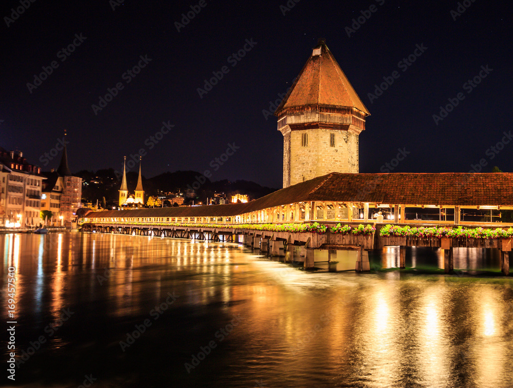 Beautiful Night view of Chapel Bridge and Water Tower with reflection on the lake, Lucerne, Switzerland, Europe
