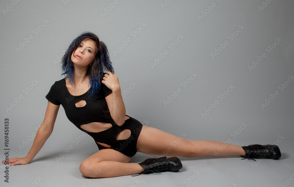 Woman Sitting on Floor in Cut Out Black Leotard and Ankle Boots
