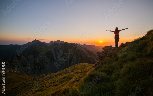 Girl watching sunset in Fagaras mountains