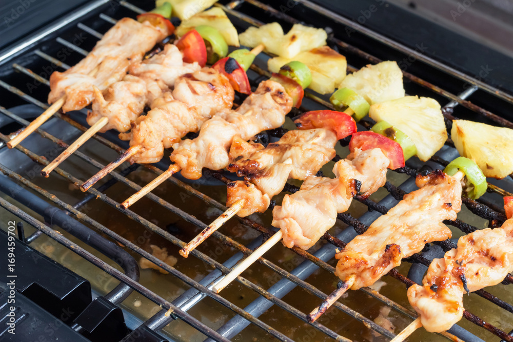 Close Up,Grilled chicken barbecue with bamboo skewers on Electric grill