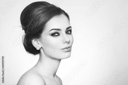 Black and white portrait of young beautiful woman with stylish hair bun