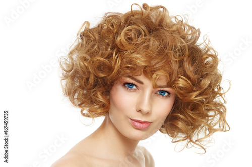 Young beautiful healthy woman with stylish curly hairdo over white background