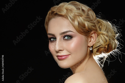 Young beautiful blonde woman with stylish prom hairdo