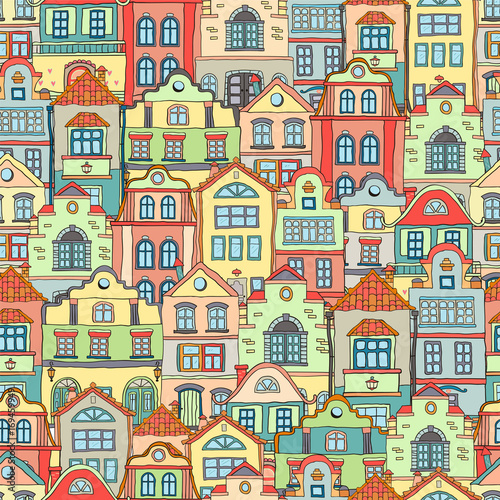Seamless pattern with doodles colored scandinavian houses . Vector background .