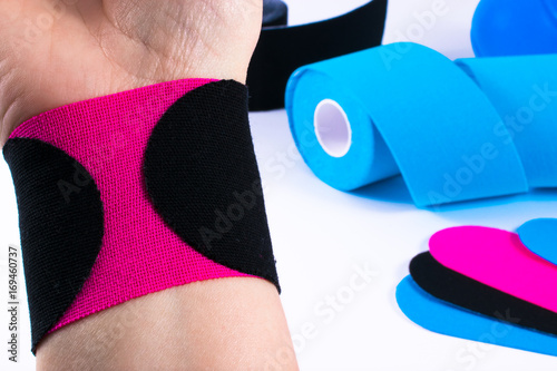 hand with kinesiology tape. Physiotherapy and therapeutic tape for wrist pain, aches and tension. elastic therapeutic tape. adhesive tape and alternative medicine. photo