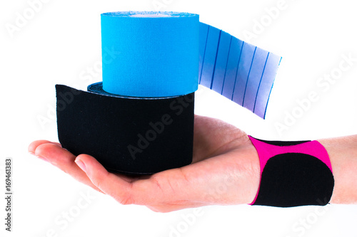 hand with kinesiology tape. Physiotherapy and therapeutic tape for wrist pain, aches and tension. elastic therapeutic tape. adhesive tape and alternative medicine. photo