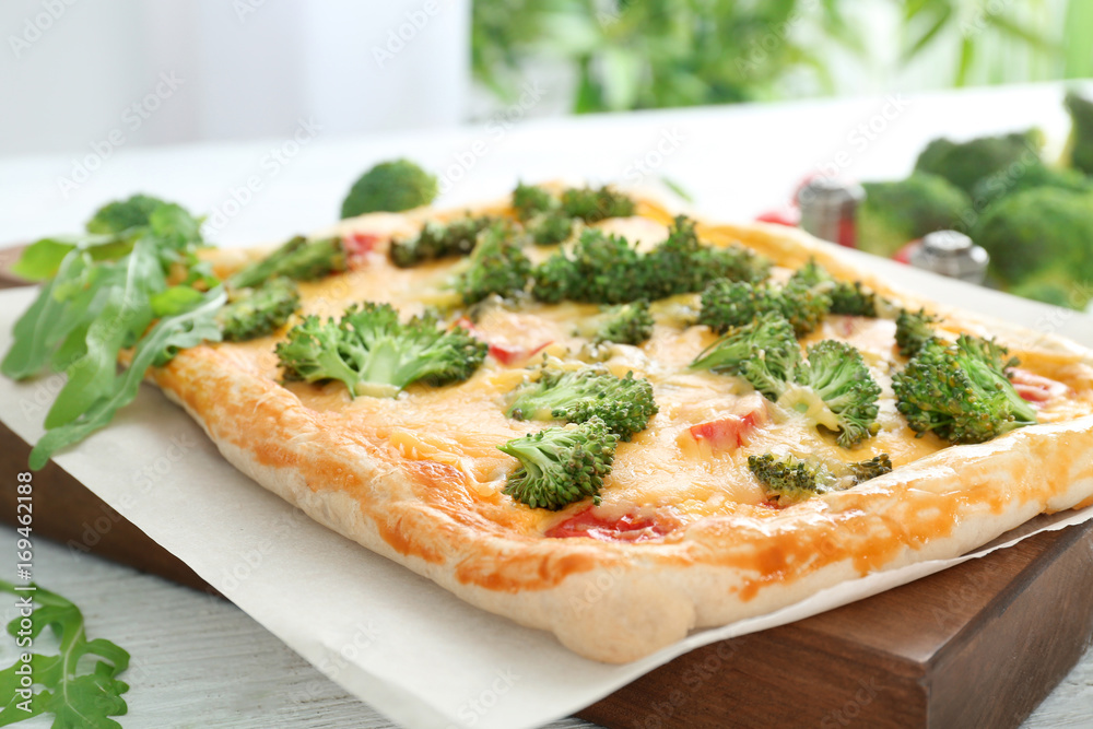 Traditional quiche with broccoli and cheese on board, close up Traditional quiche with broccoli and cheese on board, close up