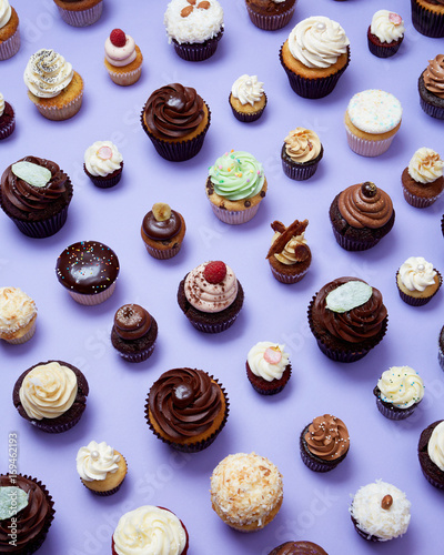 Gourmet Cupcakes in Grid Pattern on Purple Background